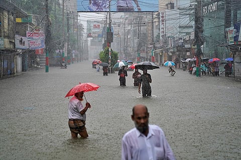 Bangladesh Floods: People navigate a flooded street in Feni district 